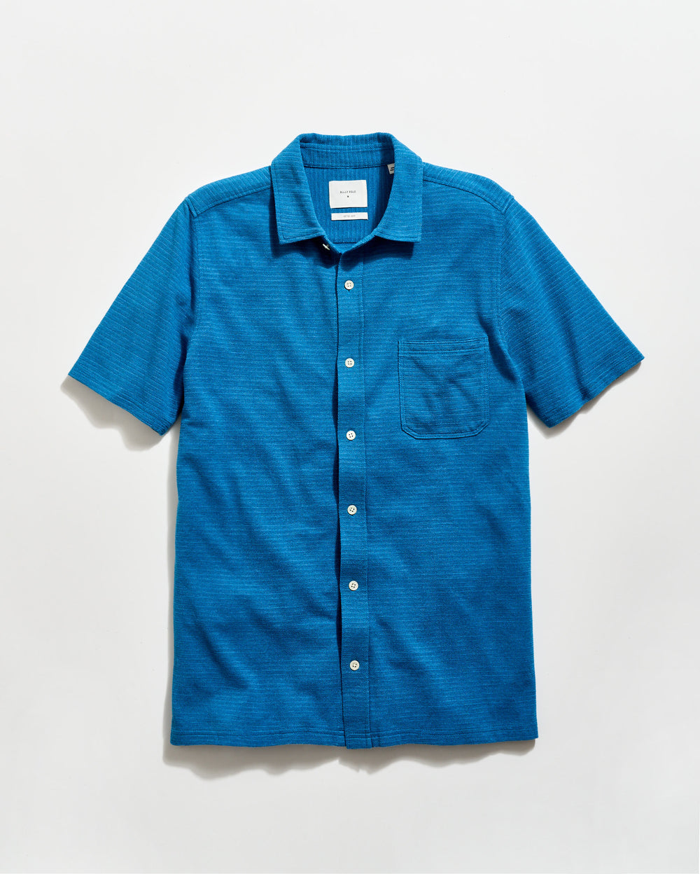 Blue short-sleeve shirt with a collar on a light gray background