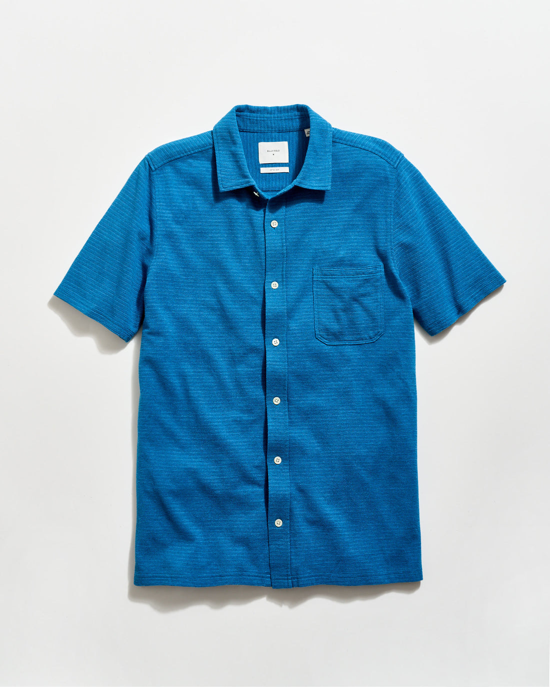 Blue short-sleeve shirt with a collar on a light gray background