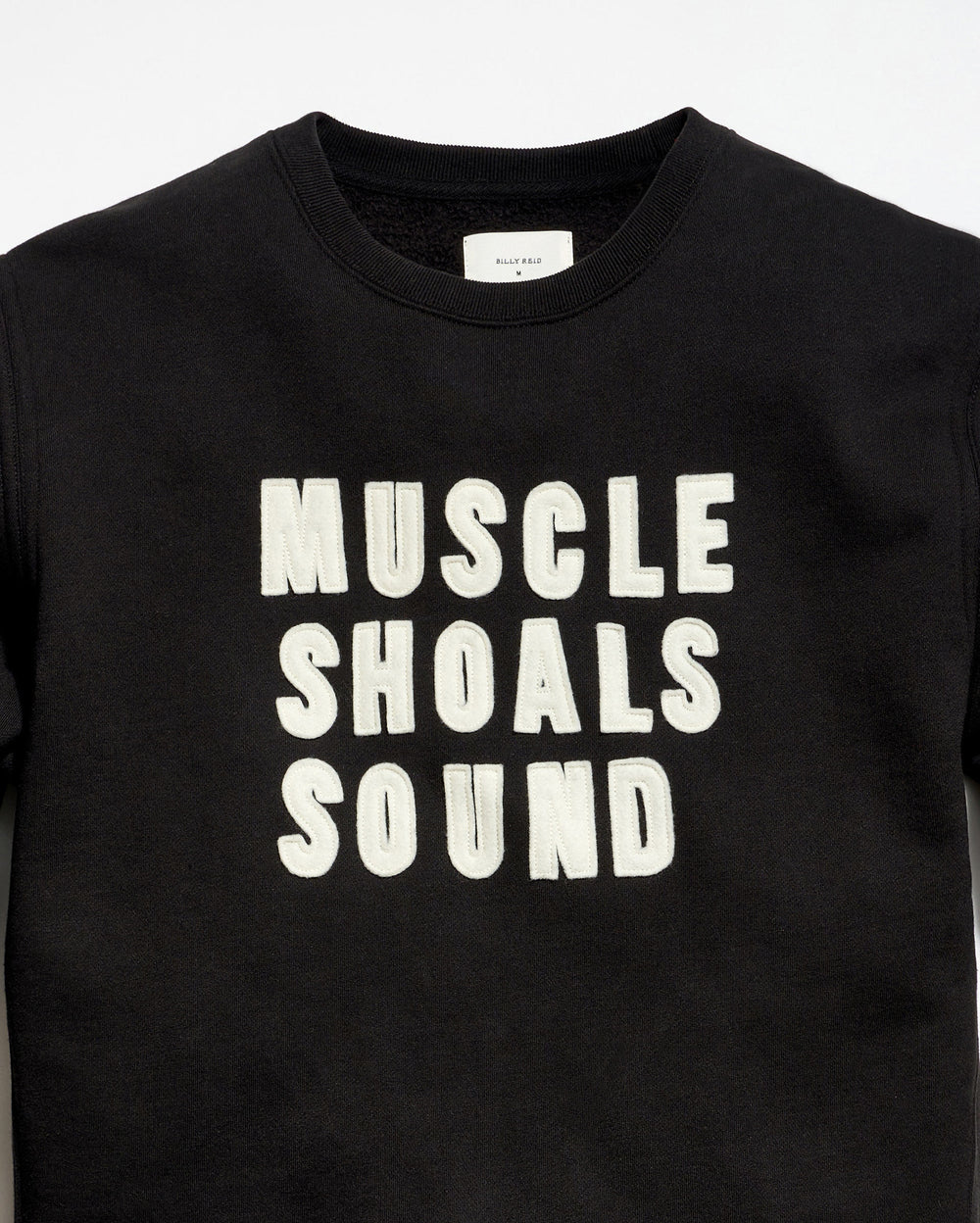 Black t-shirt with 'MUSCLE SHOALS SOUND' text on a white background