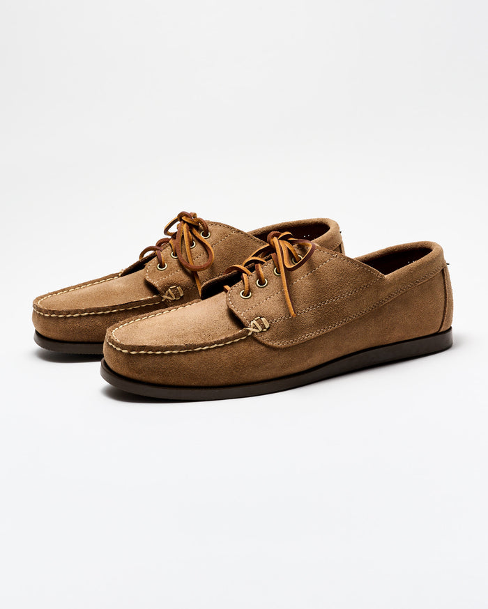 Pair of brown suede shoes on a white background
