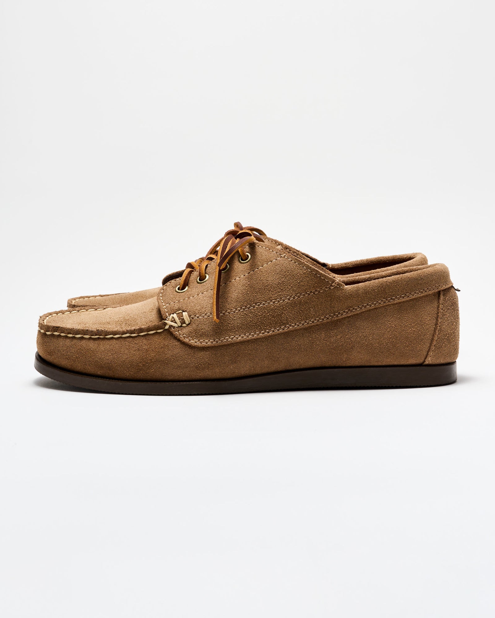 Brown suede boat shoe on a white background