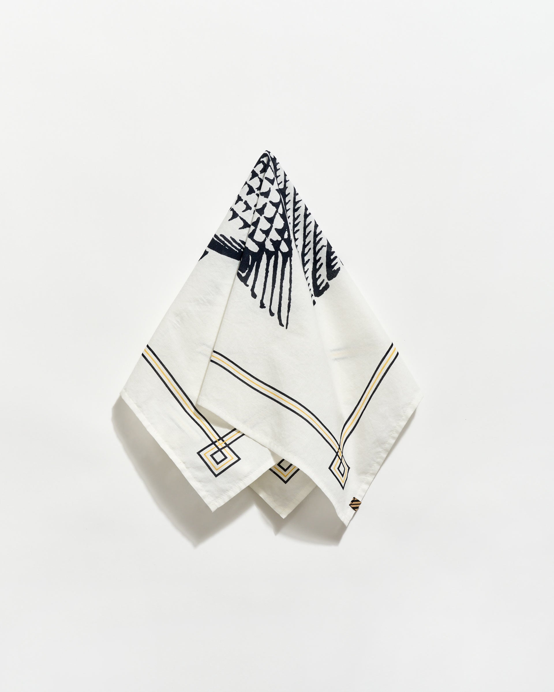White napkin with black geometric pattern on a white background